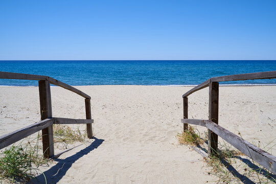 Jetty to Ascea beach in the Salerno region of southern Italy. An empty beach with beautiful sea and blue sky. Space for text.