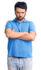 Fototapeta premium Young hispanic man wearing casual clothes skeptic and nervous, disapproving expression on face with crossed arms. negative person.