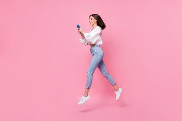 Fototapeta na wymiar Full length profile side photo of pretty lady chatting colleagues remote distance work walk empty space isolated pink color background