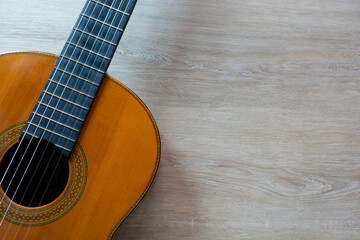 old classic guitar on wooden table background, music concept