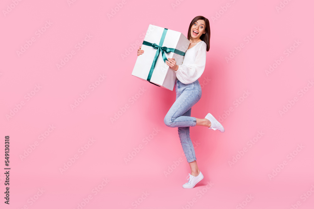 Sticker full length photo of impressed cute lady hand hold carry huge box celebrate anniversary empty space 