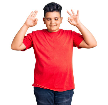 Little boy kid wearing casual clothes relax and smiling with eyes closed doing meditation gesture with fingers. yoga concept.