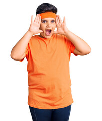 Fototapeta premium Little boy kid wearing sportswear smiling cheerful playing peek a boo with hands showing face. surprised and exited