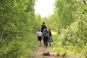 Fototapeta premium family walking in the woods