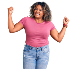 Young african american plus size woman wearing casual clothes showing arms muscles smiling proud. fitness concept.