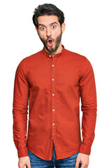 Young hispanic man wearing casual clothes afraid and shocked with surprise expression, fear and excited face.