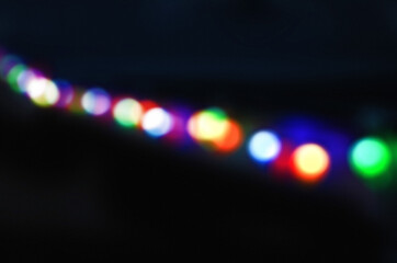 rainbow holiday new year party string lights bokeh overlay on a black background