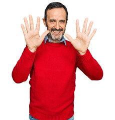 Middle age hispanic man wearing casual clothes showing and pointing up with fingers number ten while smiling confident and happy.