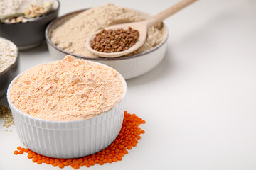 Different types of flour on white table, closeup