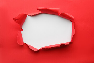 Hole in red paper on white background - Powered by Adobe