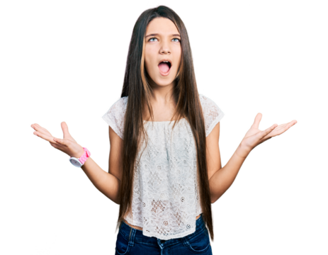Young brunette girl with long hair wearing white shirt crazy and mad shouting and yelling with aggressive expression and arms raised. frustration concept.