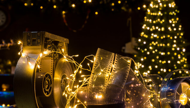 christmas background with film strip and movie camera cassette against the background of christmas lights