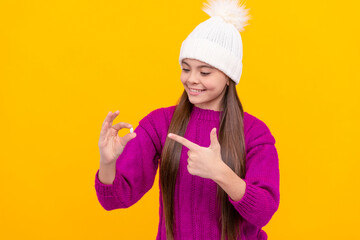 happy teen girl wear hat pointing finger on multivitamins, medicine