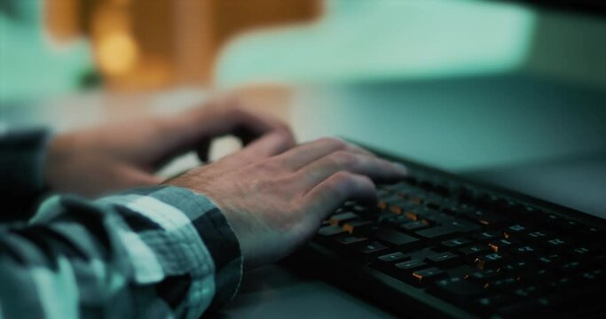Close-up of a developer's hands working and writing code for a project using a computer keyboard. Worker from a digital agency typing on desktop keyboard. Blogger writing a post for social media.