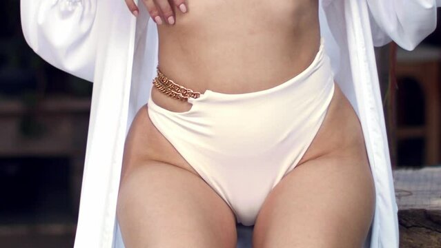 Glamorous shot of woman's hips in a bikini, slow motion