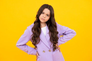 Fototapeta premium Portrait of angry teen girl looking at camera isolated on studio background. Unhappy upset teenager child.