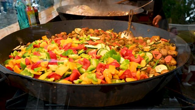 Cooking vegetable in big pan. Street food.