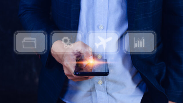 Businessman touching smartphone to select flight by pressing touch screen airplane button,Business Airplane transportation concept - Powered by Adobe