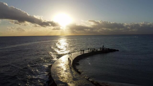 Sunrise at Baker's Haulover Inlet and park & Bal Harbour Miami - Drone Footage - Flying into ocean - people standing on inlet and Boat cruising accross