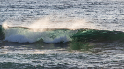 Wave barrel breaking in the ocean.