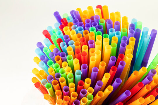 Heap of colorful plastic straws for drinks as background, closeup view macro plastic tubes, Fancy straw multicolor background