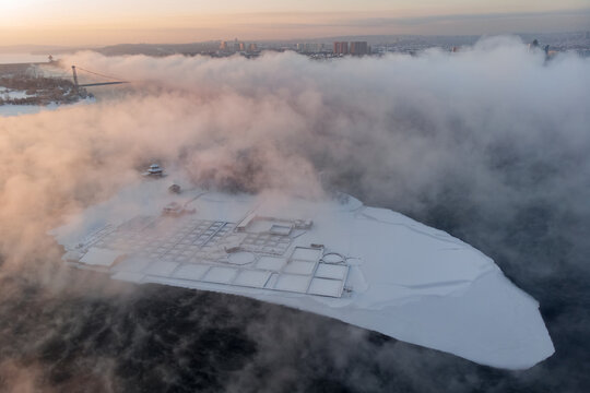 Winter fog on the Angara river around the island
