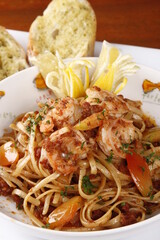 Shrimp pasta with tomatoes, tomato sauce and lemons
