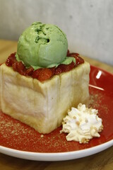 Bread pudding with strawberry and matcha green tea ice cream