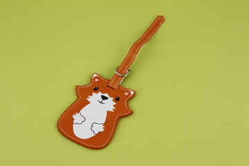 Cartoon fox leather bag tag for luggage on a green background