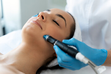 Close-up of woman getting facial hydro microdermabrasion peeling treatment