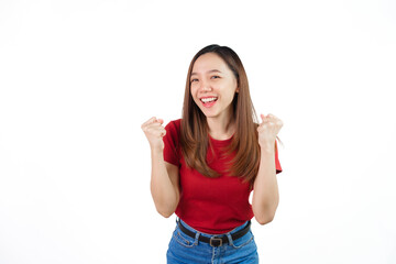 Obraz na płótnie Canvas Pretty Asian people wearing red t-shirt for a woman isolated on white background. Successful young woman achieve goal or prize, raising hands up and scream yes with joy and excitement.