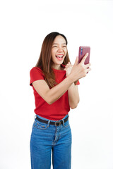 Fototapeta premium Holding mobile, Pretty asian women England soccer fans celebrating over white background isolated. Sports fan isolated young woman.