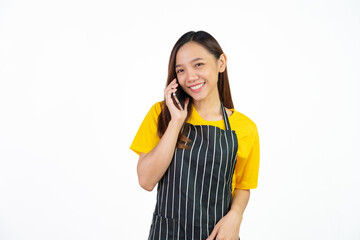 Call a mobile phone with customer, Portrait of confident asian woman barista and food owner shop with yellow t-shirt and black apron standing on white background.