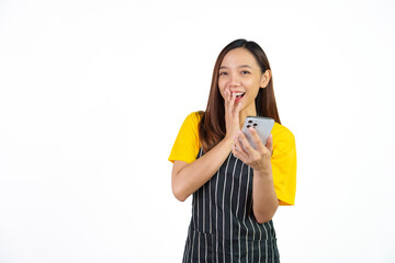 Received customer online order on mobile app, Portrait of confident asian woman barista and food owner shop with yellow t-shirt and black apron standing on white background.