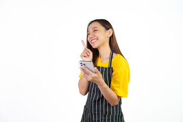 Received customer online order on mobile app, Portrait of confident asian woman barista and food owner shop with yellow t-shirt and black apron standing on white background.