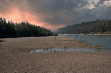 Beautiful gardens can be seen on both sides of the river. The sun is going down. natural beauty