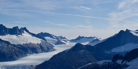 Fototapeta na wymiar Alaska mountain range snow and ice and glacier and blue sky and white clouds