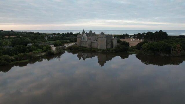 aerial drone hyperlapse at sunrise over a water mirror, with cloud movement