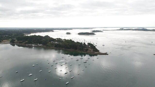 aerial drone hyperlapse at sunrise over a water mirror, with cloud movement, with boat's.