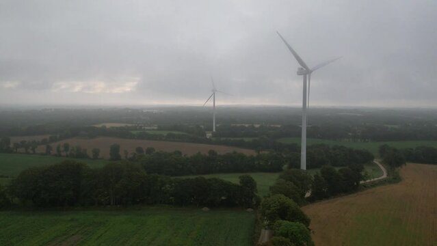 Timelapse drone view of wind turbine with stunning clouds mouvement in the morning