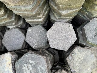 Pile of disassemble hexagon gray paving stone from top view.