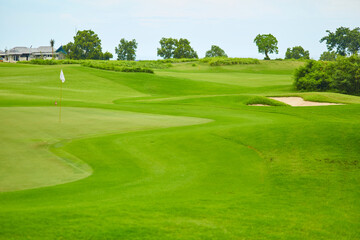 The green lawn is a relief golf course. At the local golf club