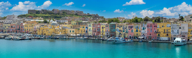 Obraz na płótnie Canvas Italy, Procida Island shoreline with shops and colorful old city buildings facing the sea