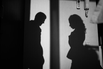 Shadow of bride and groom couple on the wall, black and white, wedding day