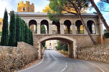 Old stone bridge with arch over the road in ancient medieval castle of Peralada.