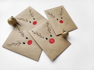Christmas kraft envelopes with funny deer, idea for decorating gifts for Christmas and Advent calendar, copy space	