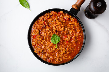 Meat tomato sauce in pan bolognese on marble surface food - obrazy, fototapety, plakaty