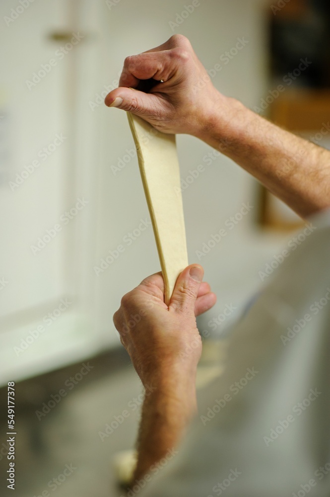 Poster Closeup of hands making croissants in a bakery