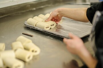 Closeup of hands making dessert in a bakery