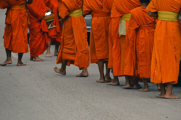 Buddhist monks during Sai Bat or Tak Bat, the traditional morning alms giving ceremony in Luang Prabang, Laos
